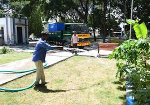 உடுமலை பார்க் ரோடு நகராட்சி பூங்காவில் உள்ள புல்தரைக்கு தண்ணீர் ...